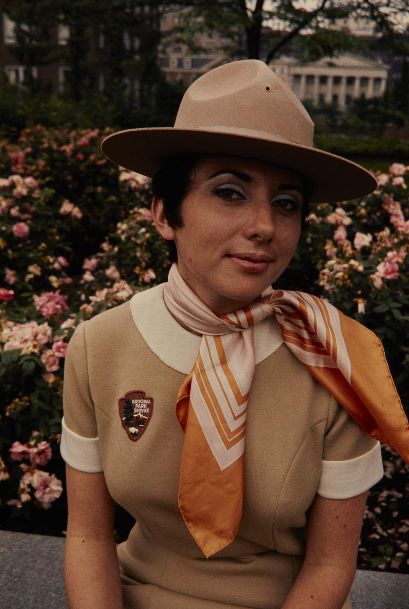 Carol Scanlon models the beige NPS women’s uniform dress, scarf, and broad brim hat. The uniform has an arrowhead patch instead of a ranger badge.